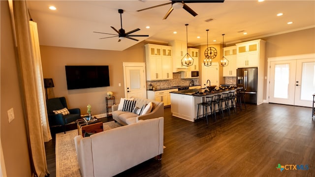 living room with dark hardwood / wood-style flooring, french doors, and ceiling fan