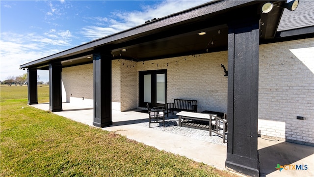 back of property with a lawn and a patio