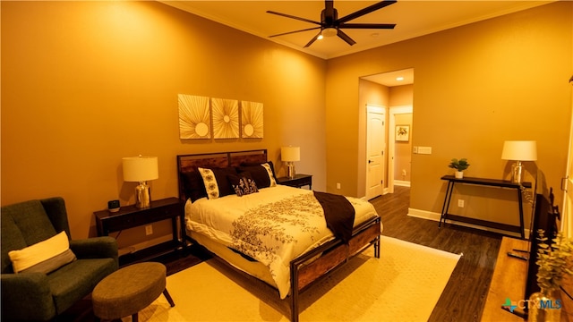 bedroom with ornamental molding, dark hardwood / wood-style floors, and ceiling fan