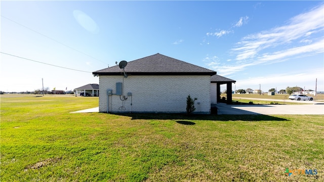 view of side of property with a lawn