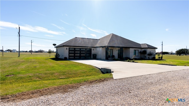 view of front of house with a garage and a front lawn