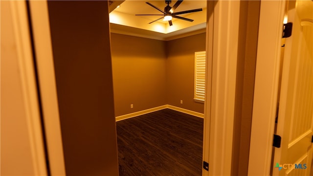 unfurnished room featuring ceiling fan, ornamental molding, a raised ceiling, and hardwood / wood-style floors