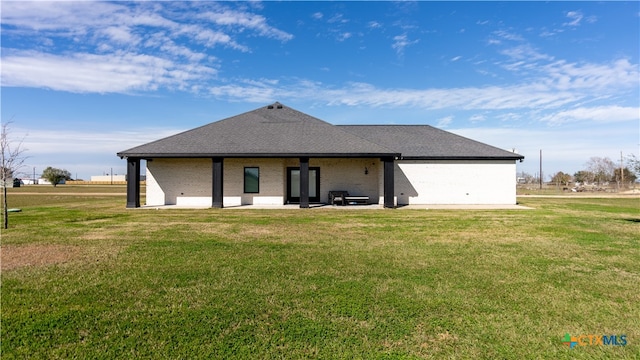 rear view of house featuring a yard