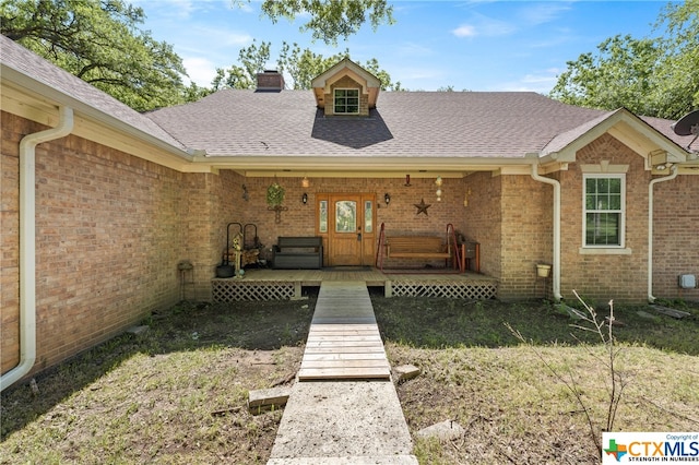 entrance to property featuring french doors and a yard