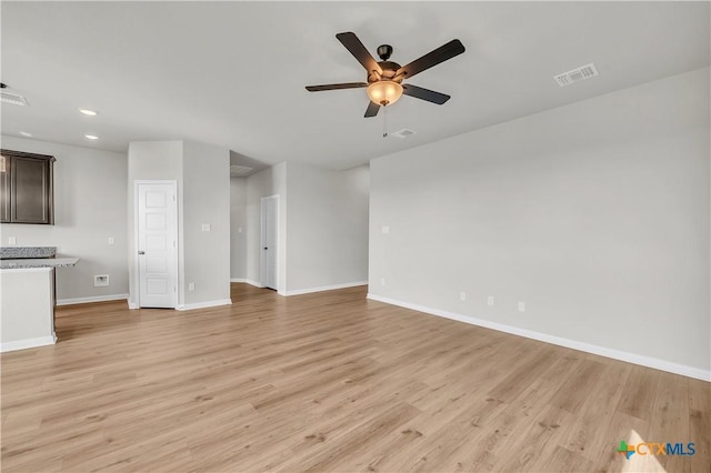 unfurnished living room featuring ceiling fan and light hardwood / wood-style flooring