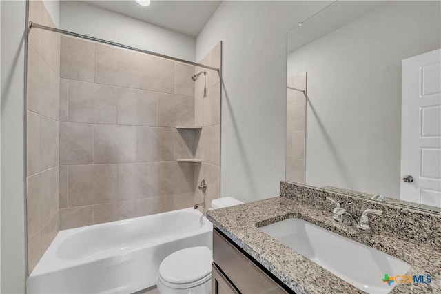 full bathroom with vanity, toilet, and tiled shower / bath