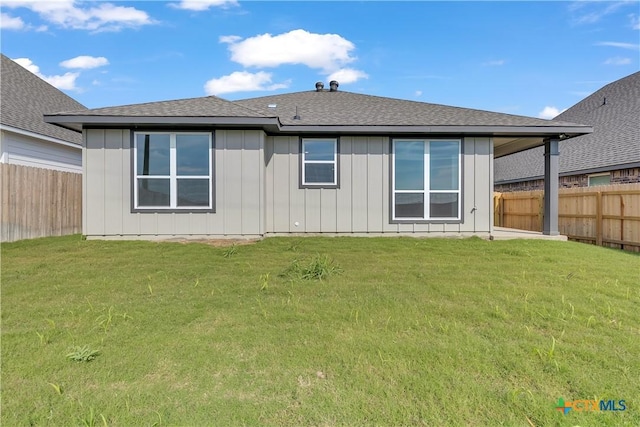 rear view of house with a yard