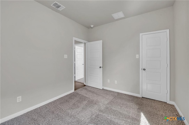 empty room with dark colored carpet