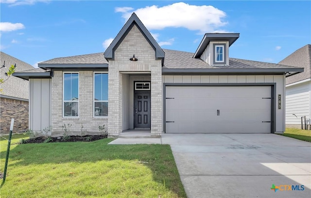 view of front of home with a garage and a front lawn