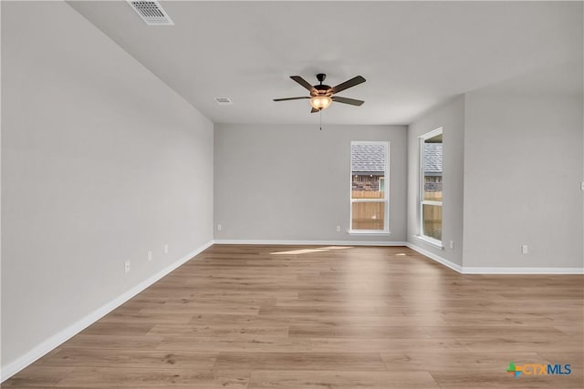 spare room featuring ceiling fan and light hardwood / wood-style flooring