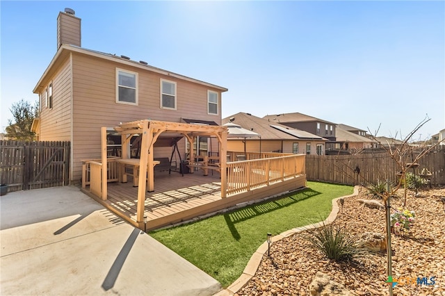 3946 Legend Pond, New Braunfels, TX 78130 - back of property with a deck, a chimney, and a patio area