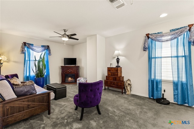 3946 Legend Pond, New Braunfels, TX 78130 - living area with carpet, a ceiling fan, a warm lit fireplace, and baseboards