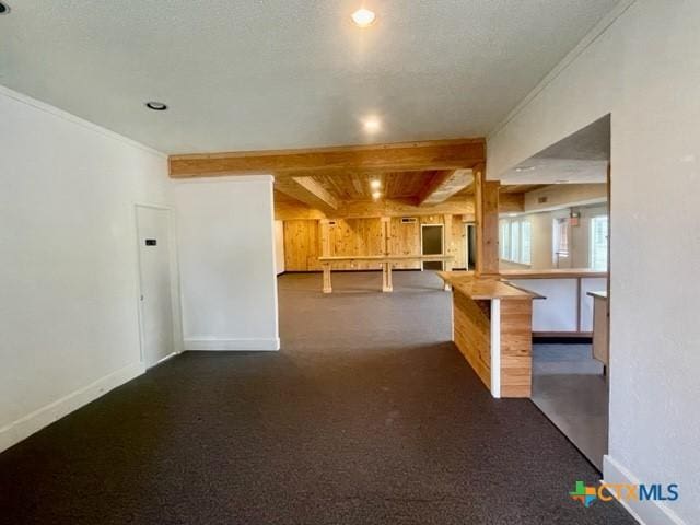 interior space with crown molding, baseboards, and a textured ceiling