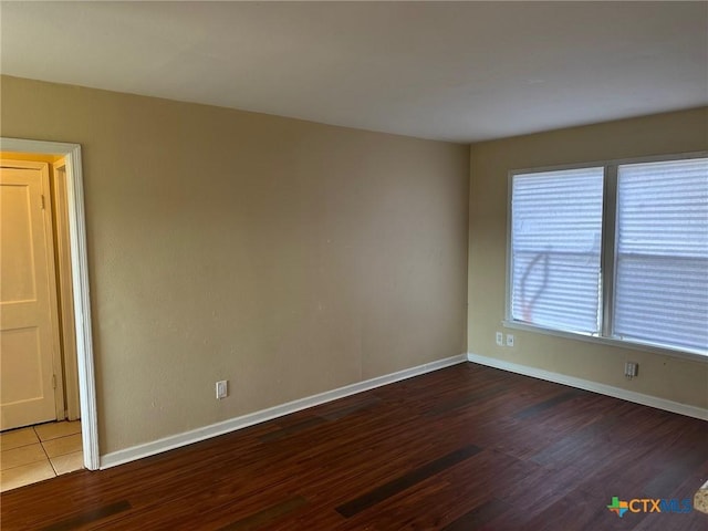 spare room with hardwood / wood-style floors