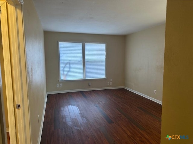 unfurnished room with dark hardwood / wood-style floors