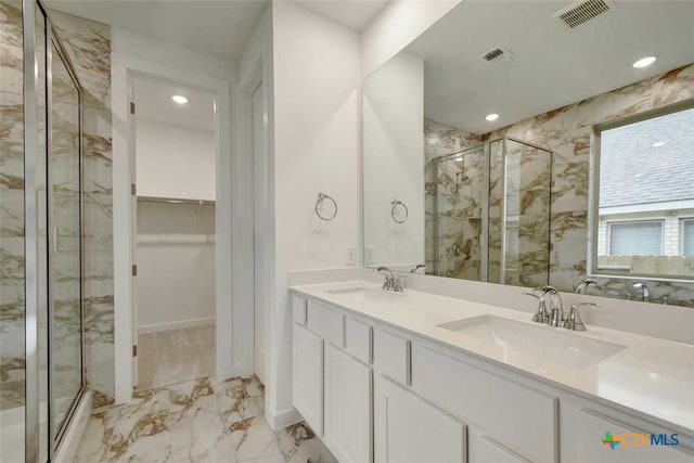 bathroom with vanity and a shower with shower door