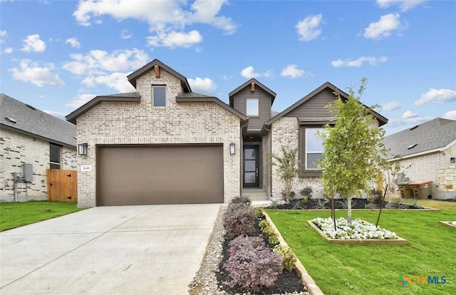 view of front of property featuring a garage and a front yard