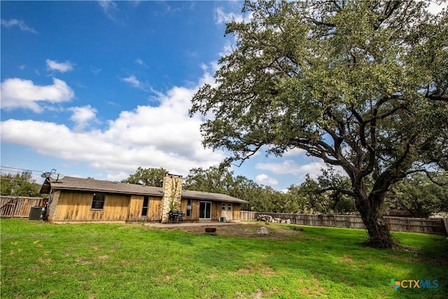 rear view of property featuring a yard