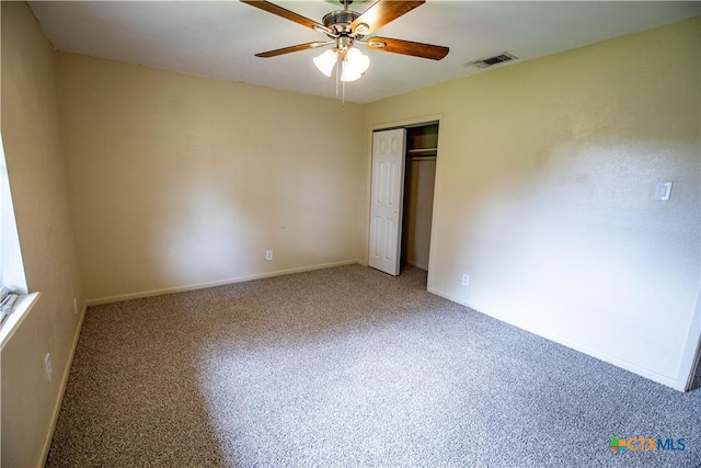 unfurnished bedroom featuring carpet, ceiling fan, and a closet