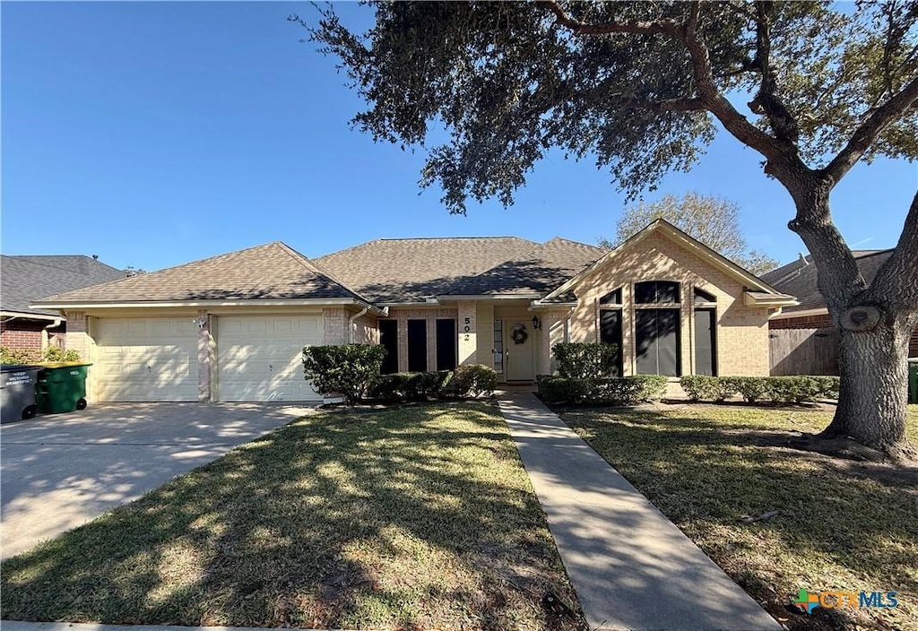 single story home with a garage and a front yard