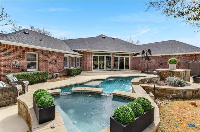 view of pool with a pool with connected hot tub and a patio