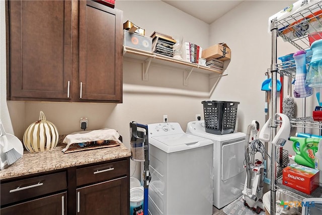 laundry area featuring washing machine and dryer and cabinets