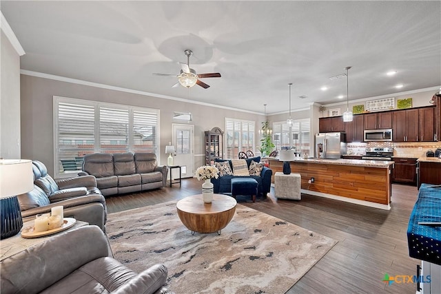 living room with dark hardwood / wood-style flooring, crown molding, and ceiling fan