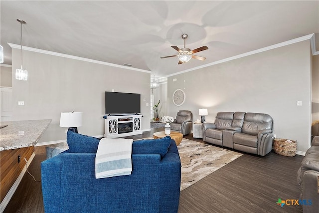 living room featuring ceiling fan, ornamental molding, and dark hardwood / wood-style floors