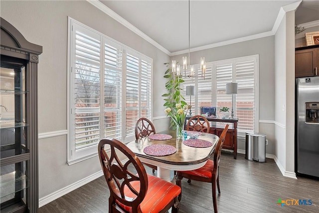 dining room featuring ornamental molding, dark hardwood / wood-style flooring, and a chandelier