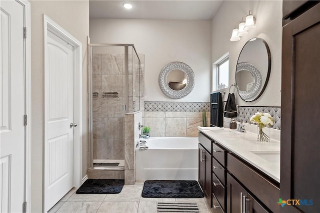 bathroom featuring independent shower and bath, vanity, and tile patterned floors