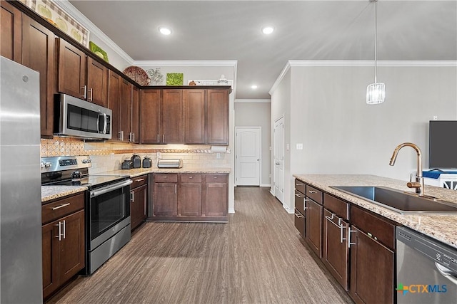 kitchen featuring dark brown cabinetry, sink, pendant lighting, stainless steel appliances, and light stone countertops