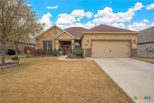 view of front of property with a garage and a front lawn