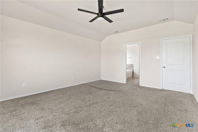 empty room with baseboards, visible vents, lofted ceiling, a ceiling fan, and carpet floors