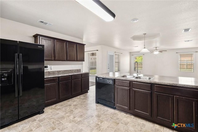 kitchen featuring black appliances, dark brown cabinets, a sink, and visible vents