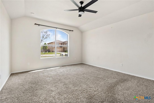carpeted empty room with lofted ceiling, baseboards, and ceiling fan