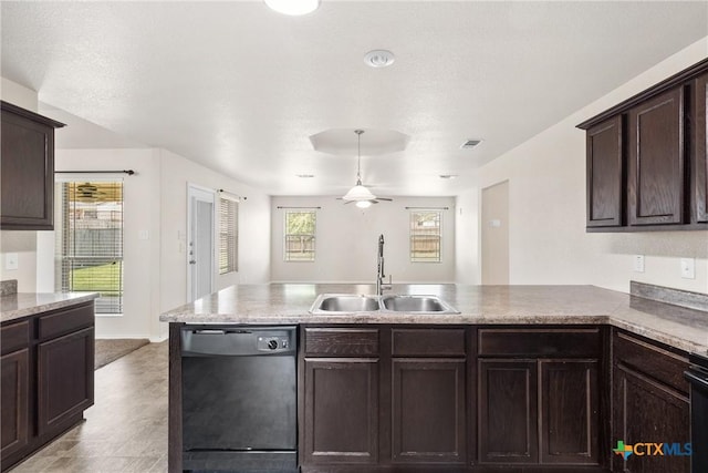 kitchen with dark brown cabinets, visible vents, a sink, a peninsula, and black dishwasher