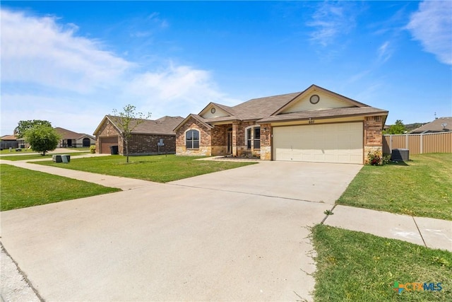 view of front of property with an attached garage, brick siding, driveway, and a front yard