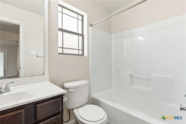 full bath with toilet, vanity, and washtub / shower combination