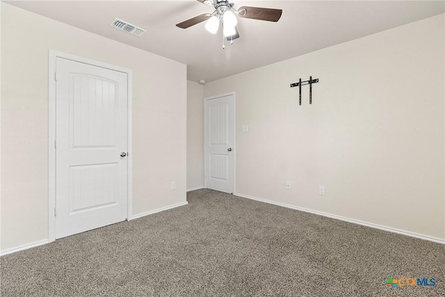 unfurnished bedroom featuring carpet floors, visible vents, baseboards, and ceiling fan
