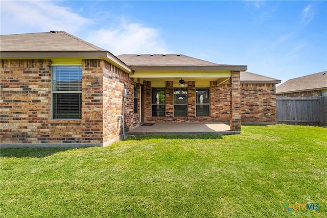 rear view of property with a patio area, fence, a ceiling fan, and brick siding