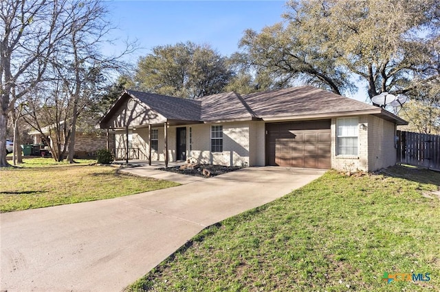 view of front of property featuring a garage, a front yard, brick siding, and fence