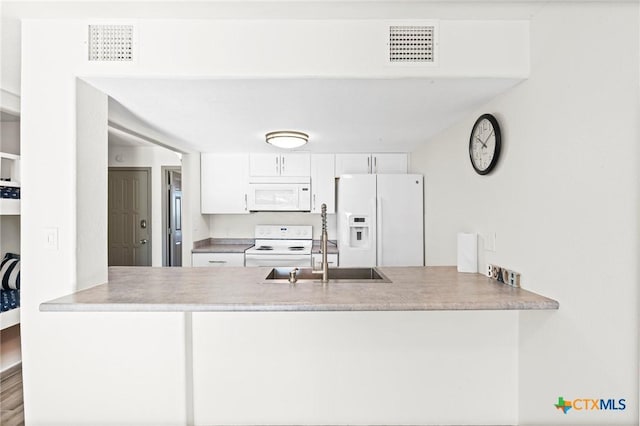 kitchen featuring white cabinetry, sink, and white appliances