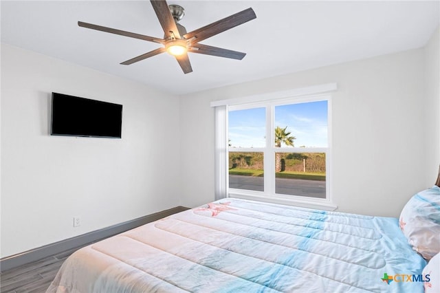 bedroom with hardwood / wood-style flooring and ceiling fan