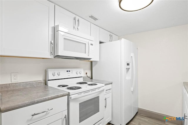 kitchen featuring white appliances, light hardwood / wood-style floors, and white cabinets