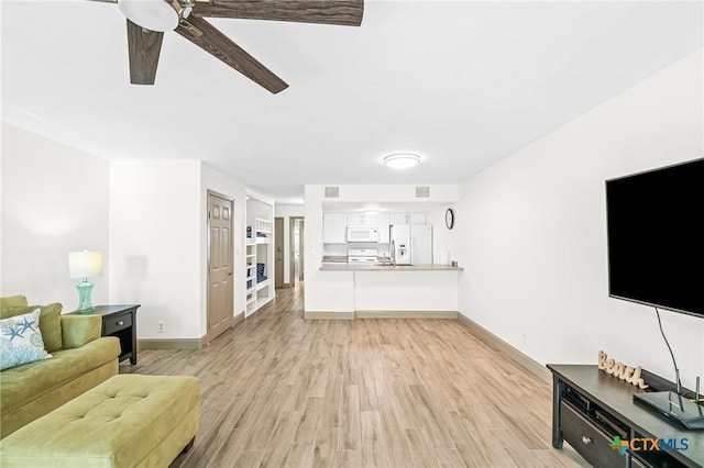 living room with light hardwood / wood-style flooring and ceiling fan