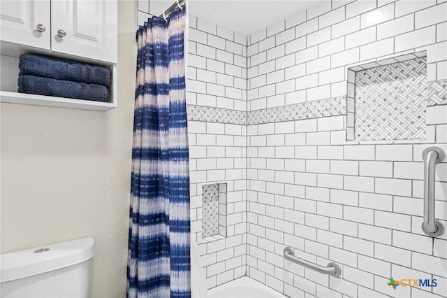 bathroom featuring shower / bathtub combination with curtain and toilet