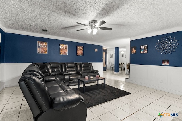 tiled living room with a textured ceiling and ceiling fan