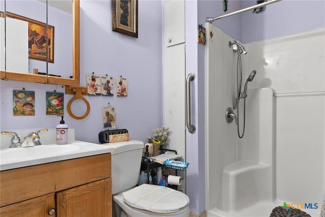 bathroom featuring walk in shower, vanity, and toilet