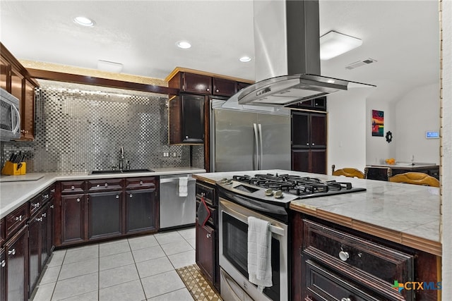 kitchen with island range hood, tasteful backsplash, stainless steel appliances, light tile patterned floors, and sink