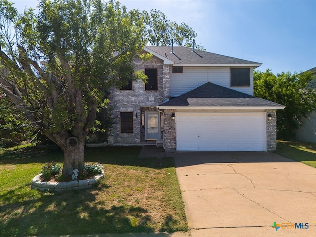 view of front of property featuring a garage and a front lawn